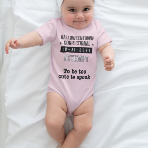 baby girl wearing a pink onesie that says halloweentown correctional attempt to be too cute to spook family costume