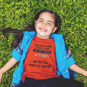 girls outside wearing a tee shirt that says HalloweenTown Correctional attempt to be too cute to spook family costume