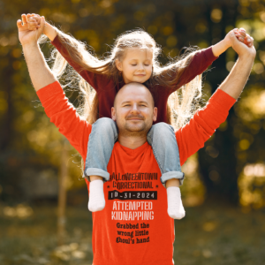 man holding a girl wearing a shirt halloweentown correctional attempted kidnapping grabbed the wrong little ghoul's hand family costume