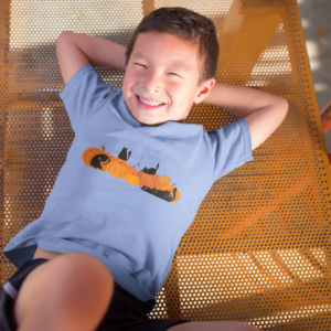 boy wearing a light blue halloween shirt that has pumpkins and black cats