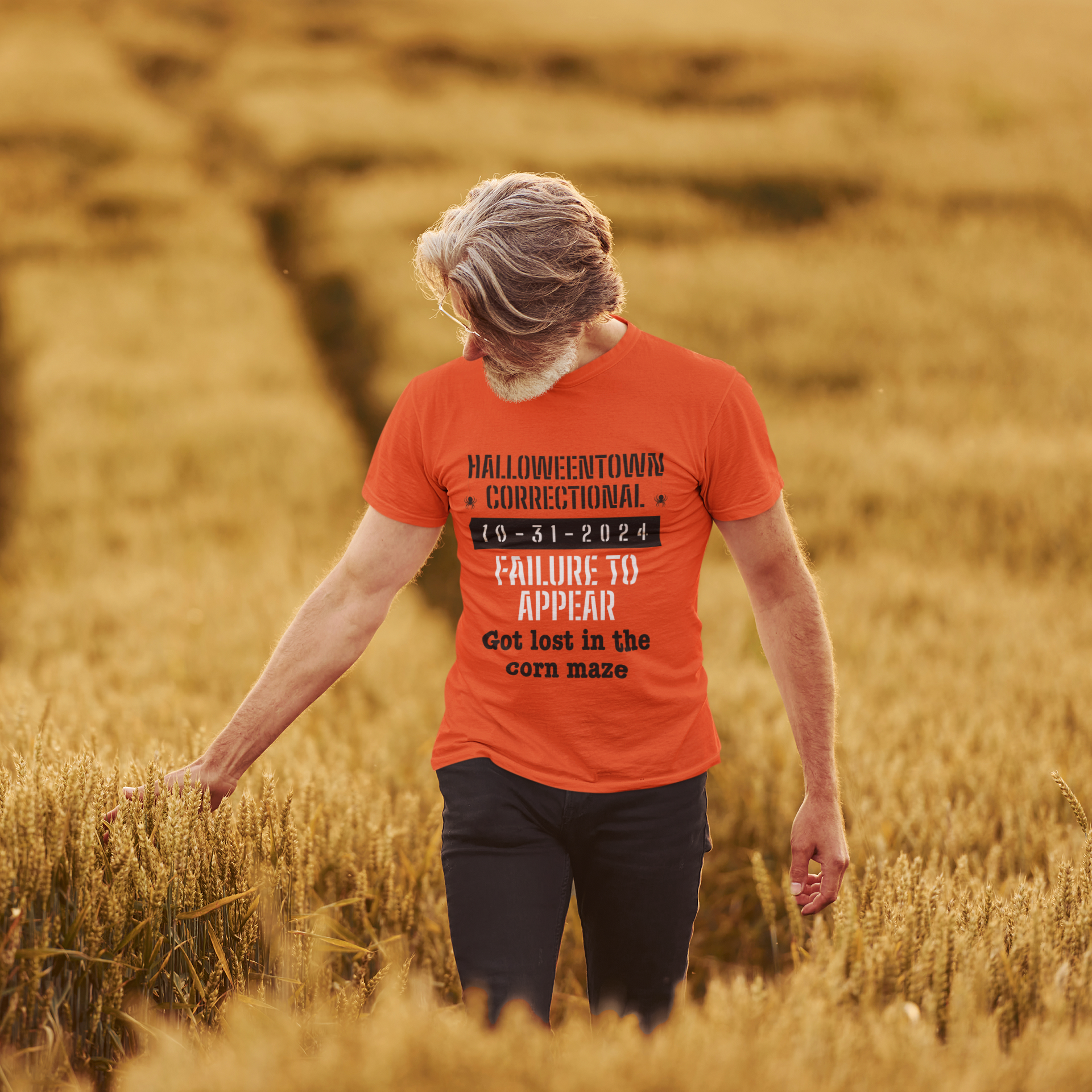 man in field wearing a shirt that says halloweentown correctional failure to appear got lost in a corn maze family costume