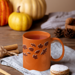 orange fall mug with dark maroon falling leaves