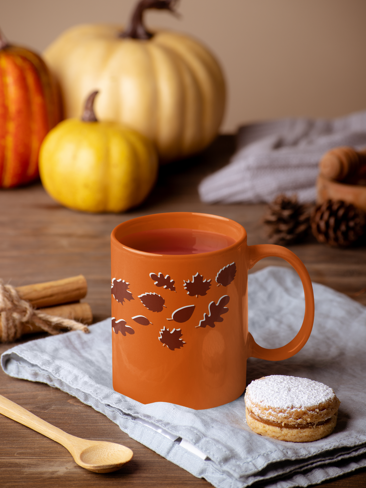 orange fall mug with dark maroon falling leaves