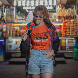 woman eating candy wearing a shirt halloweentown correctional grand theft stole all the halloween candy