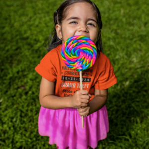 girl eating candy wearing a shirt halloweentown correctional grand theft stole all the halloween candy