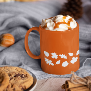 orange fall mug with a white leaf pattern towards bottom edge