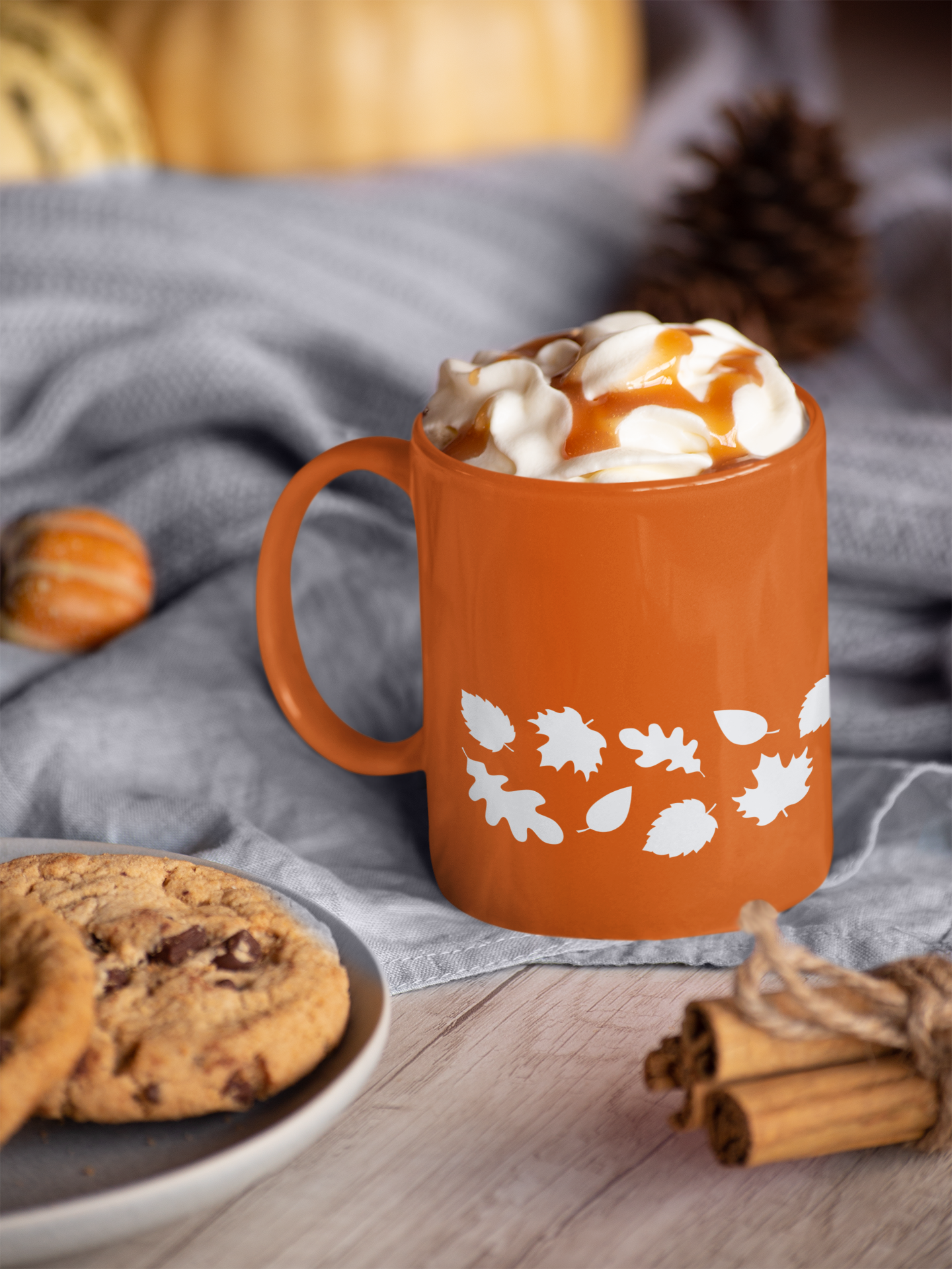orange fall mug with a white leaf pattern towards bottom edge