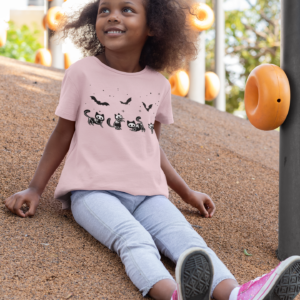 girl wearing a pink shirt with skeleton kitties and bats