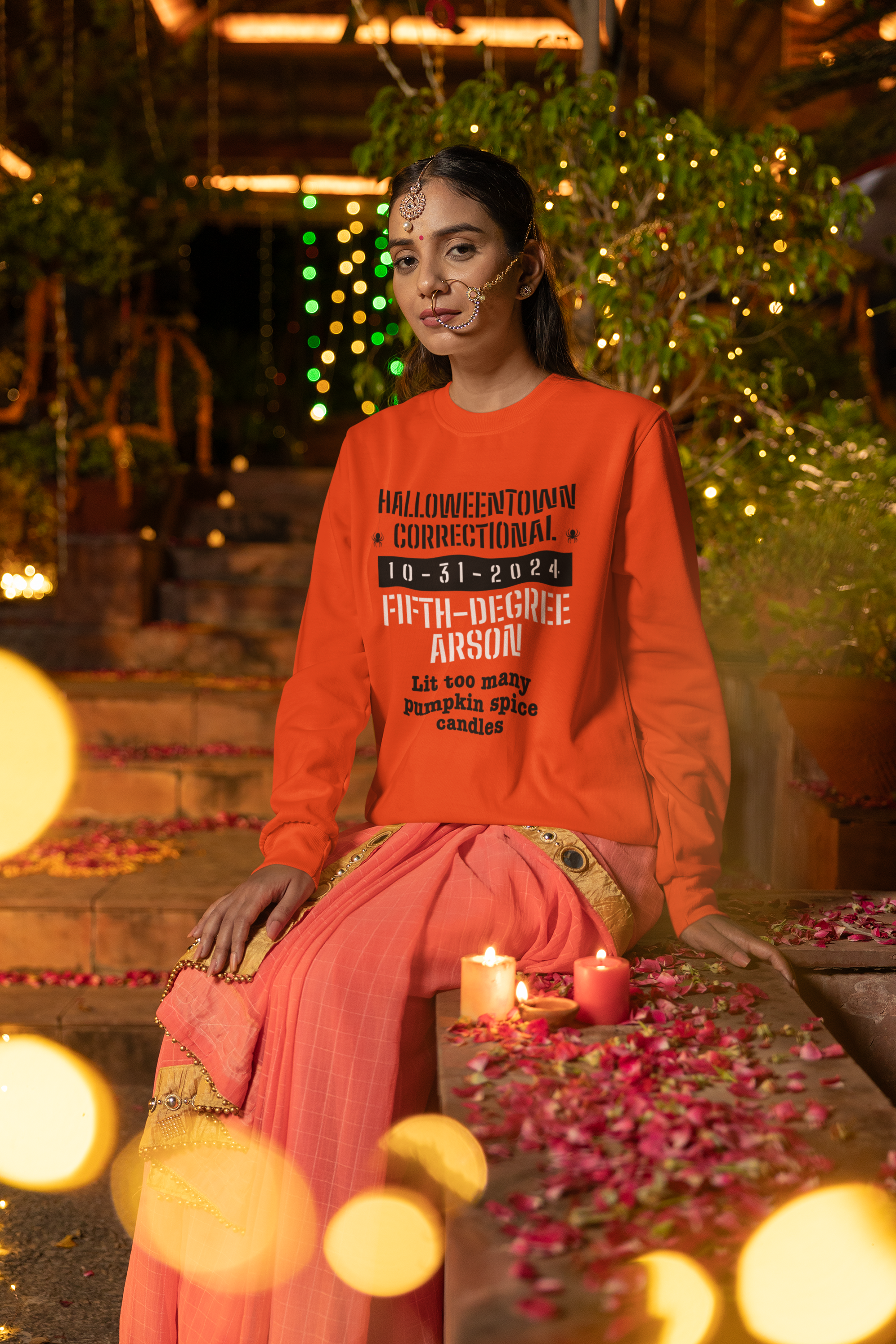 woman wearing a long sleeve orange shirt that says halloweentown correctional lit too many pumpkin spice candles family costume